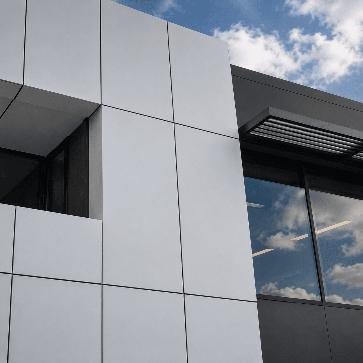 Close-up ACM panel corner detail and reveal lines on a commercial building