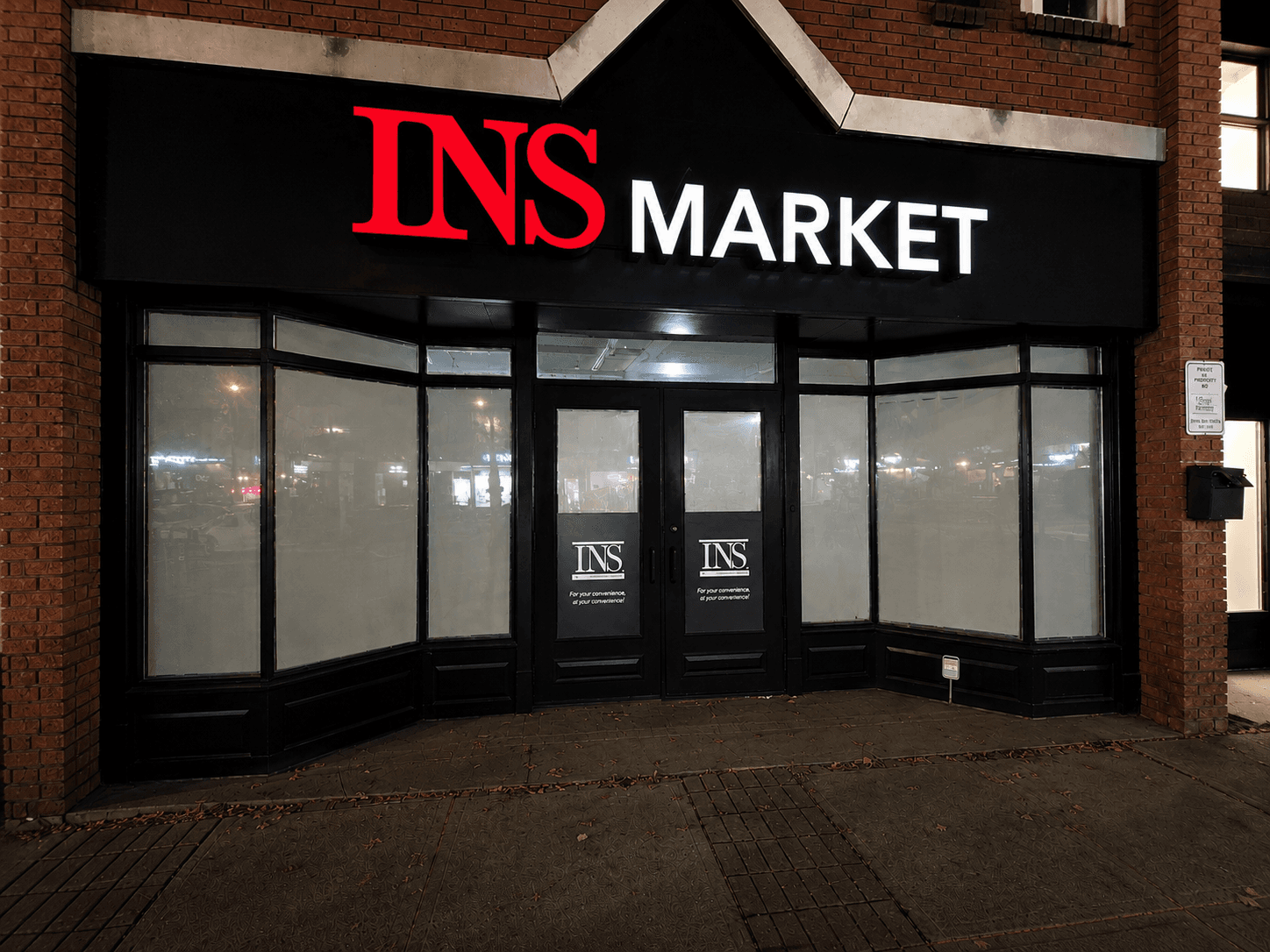 INS Market illuminated channel letter storefront sign at night