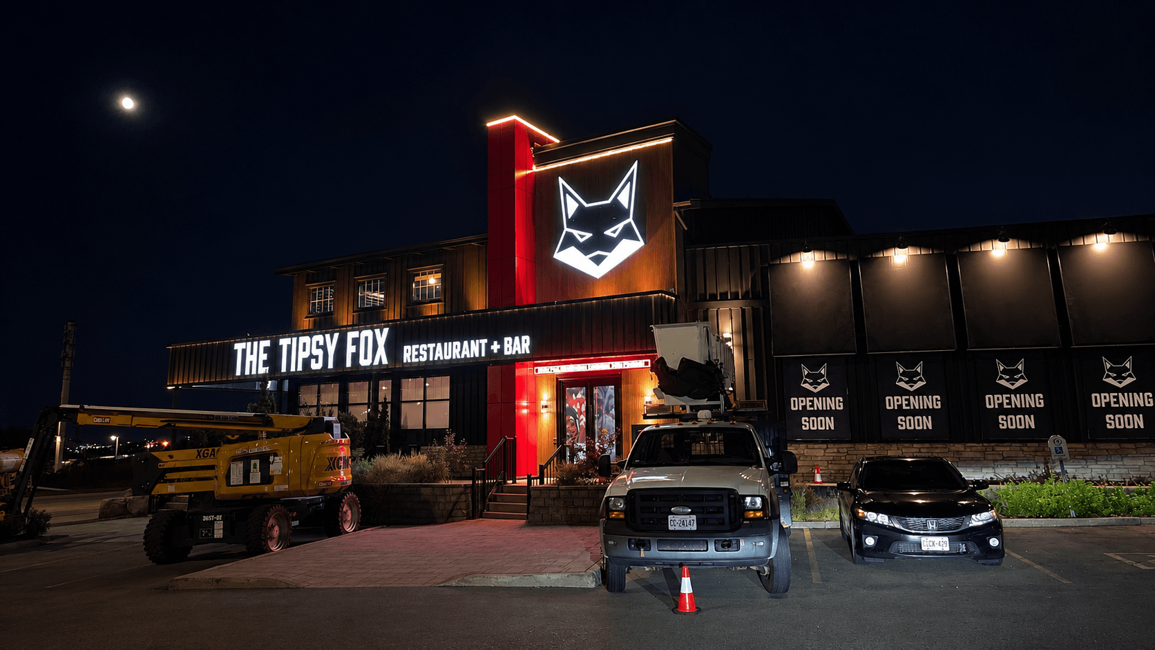 The Tipsy Fox full building at night with illuminated wordmark sign and fox logo
